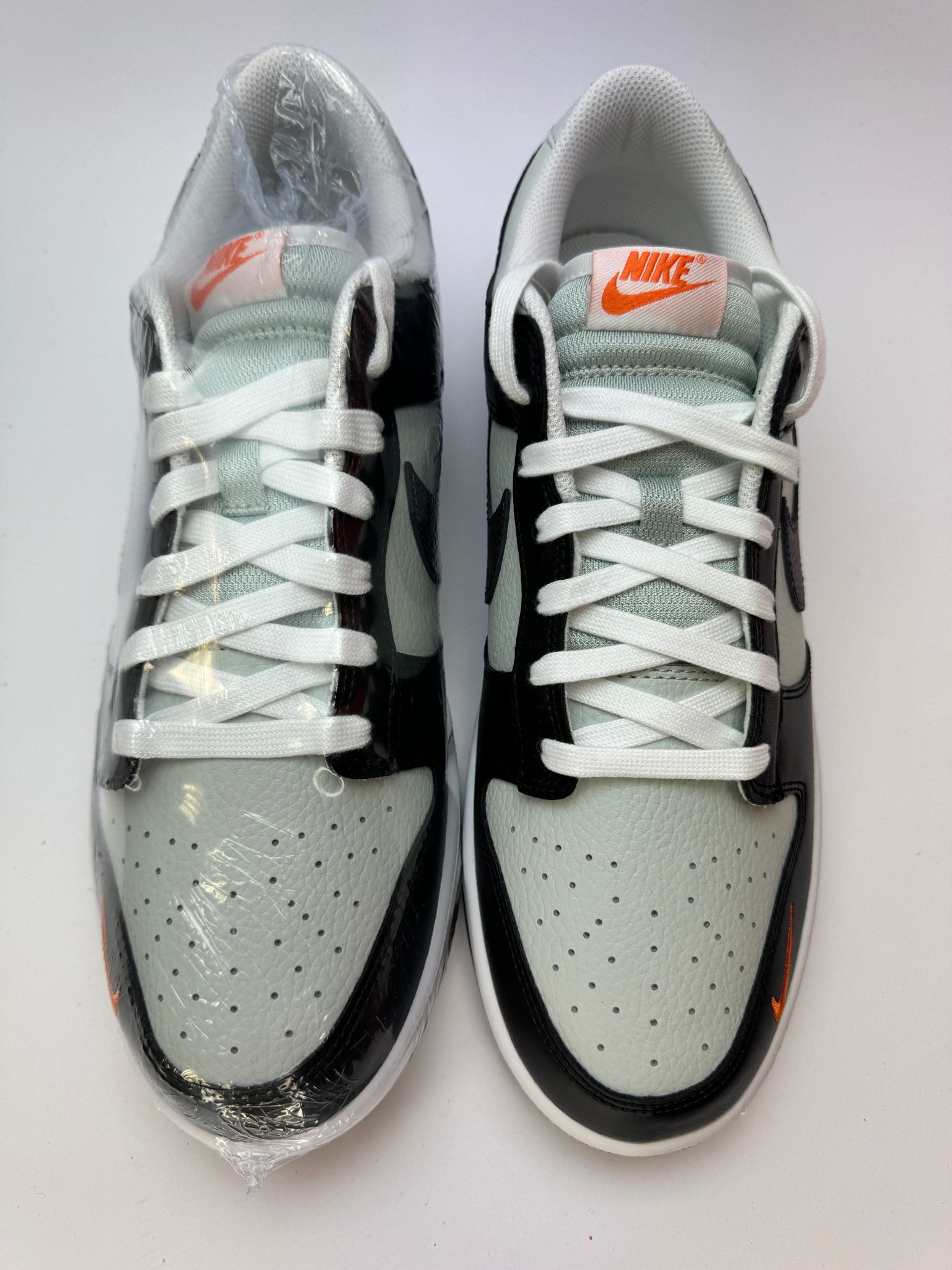 Detailansicht der Zunge – Nike Dunk Low Black/Total Orange mit gewebtem Dunk-Label und orangem Branding